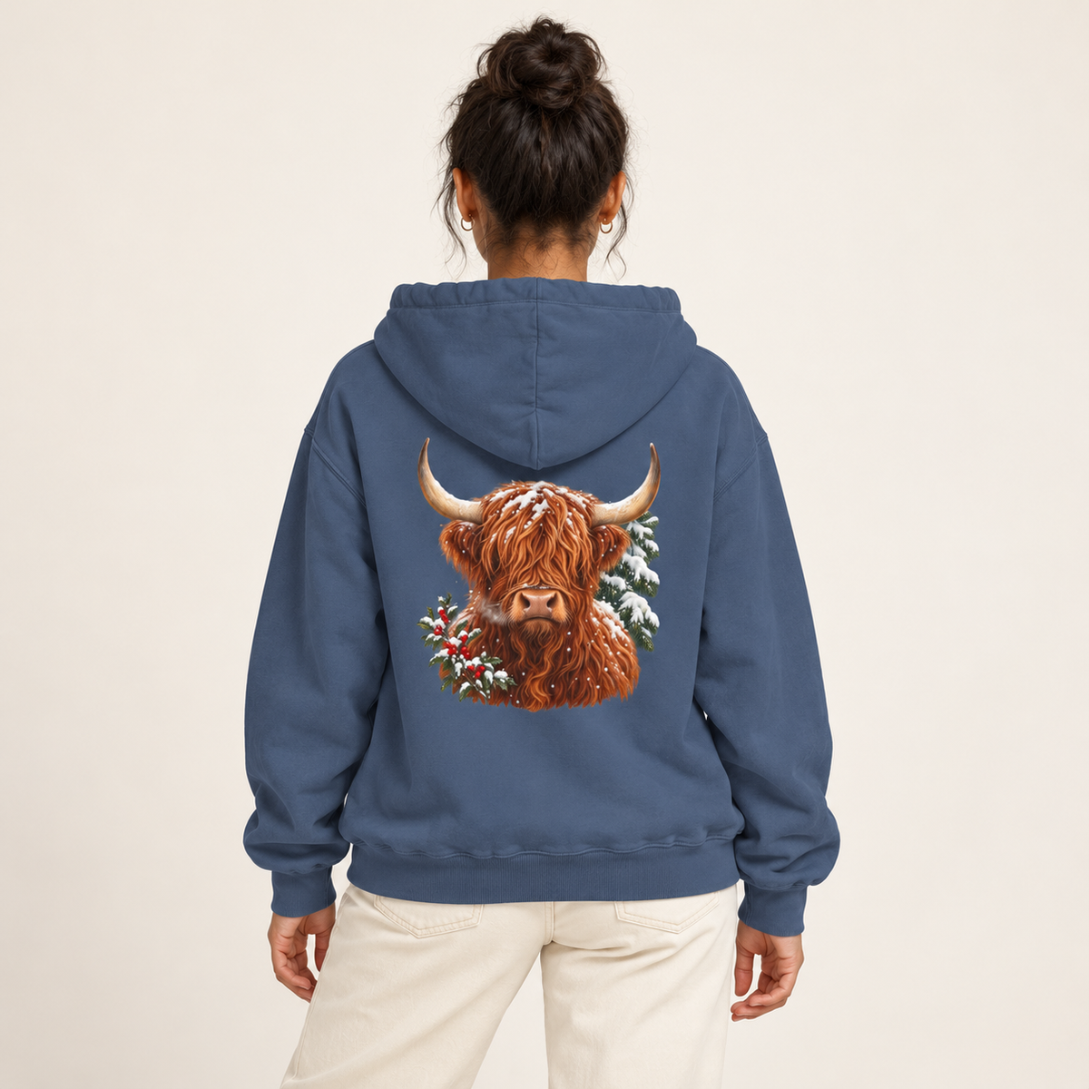 Winter Highland Cow hoodie in Denim worn, highland cow with holly and snowy pine