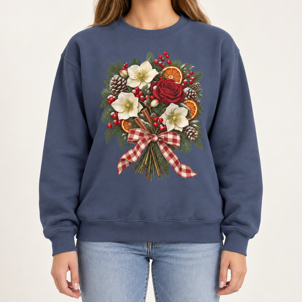 Winter bouquet sweatshirt – cream hellebores, a red rose, dried orange slices, cinnamon and pinecones tied with a red gingham bow, printed large on the chest of a Comfort Colors crewneck