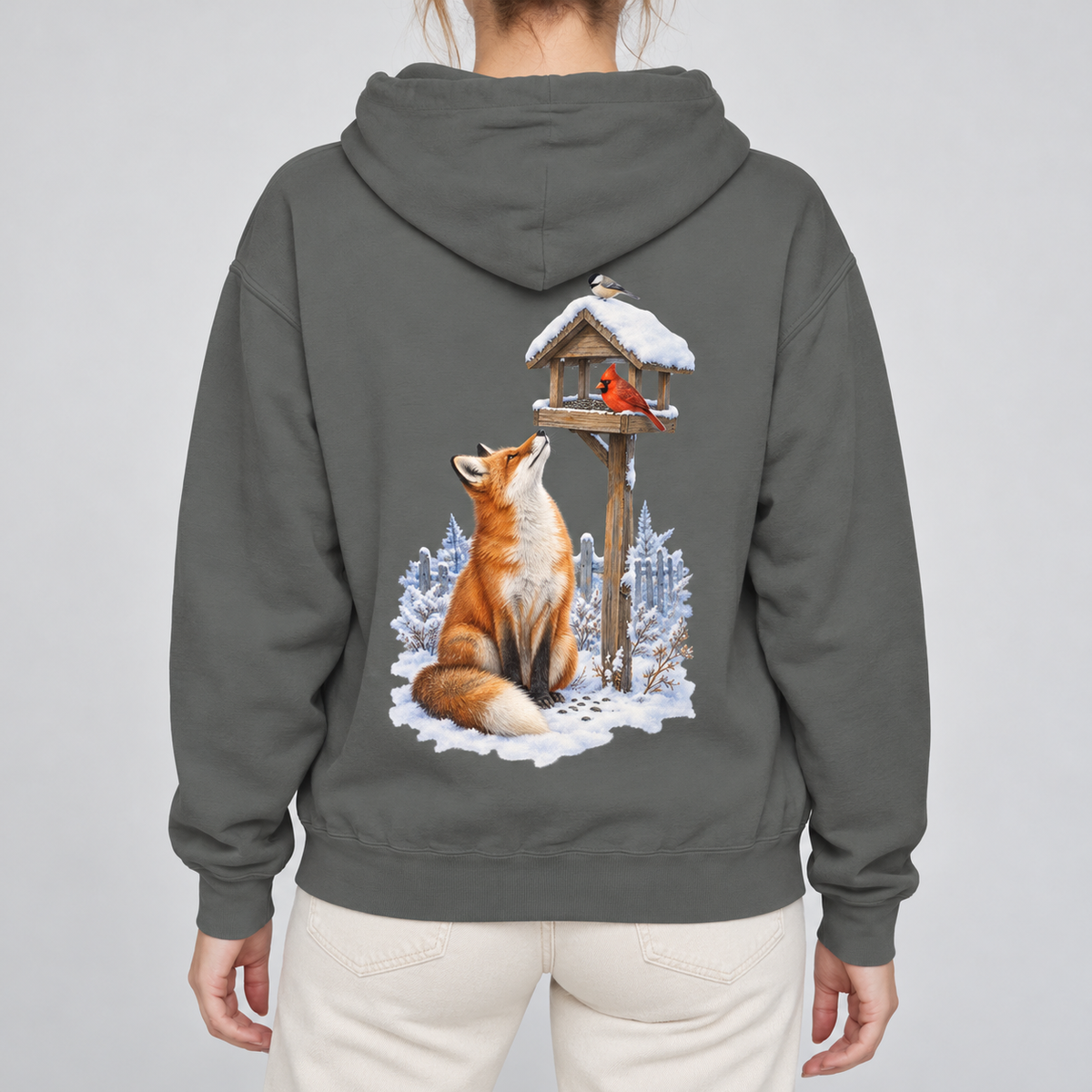Beneath the Feeder hoodie worn, back view of the red fox and cardinal feeder print