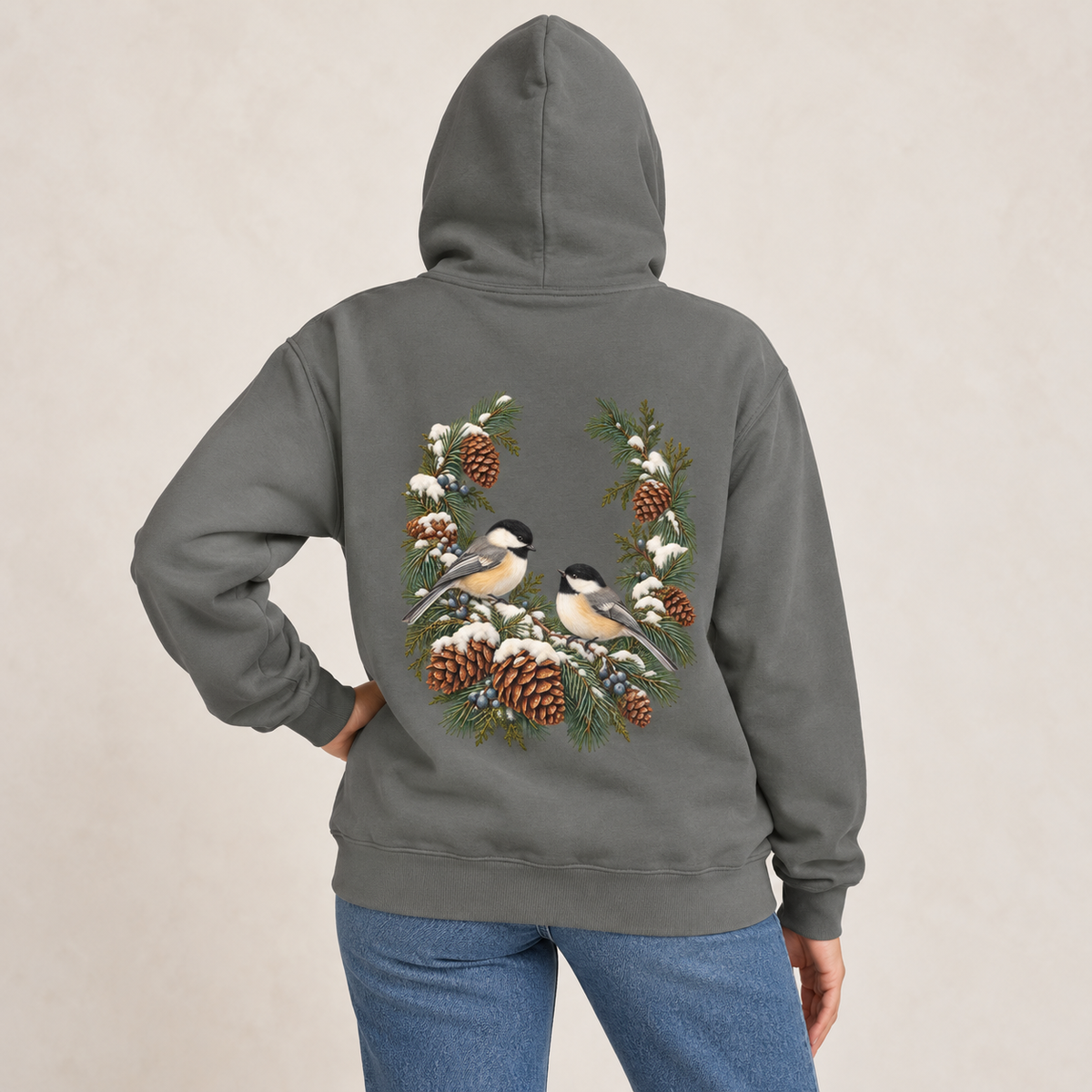 Winter Chickadee hoodie in Grey worn, back view with the chickadee and pinecone wreath