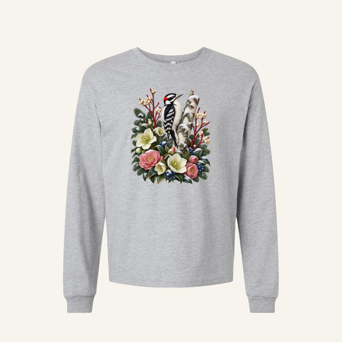 Woodpecker and Winter Florals Long Sleeve Tee in Athletic Heather — a black-and-white woodpecker with a small red patch at the back of its head, clinging to a pale birch trunk among evergreens, cream and pink flowers and winter berries