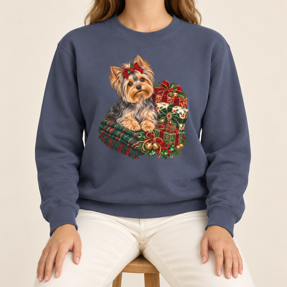 Yorkie Christmas sweatshirt – a Yorkshire terrier with a red bow on a tartan blanket beside wrapped Christmas presents, printed large on the chest of a Comfort Colors crewneck