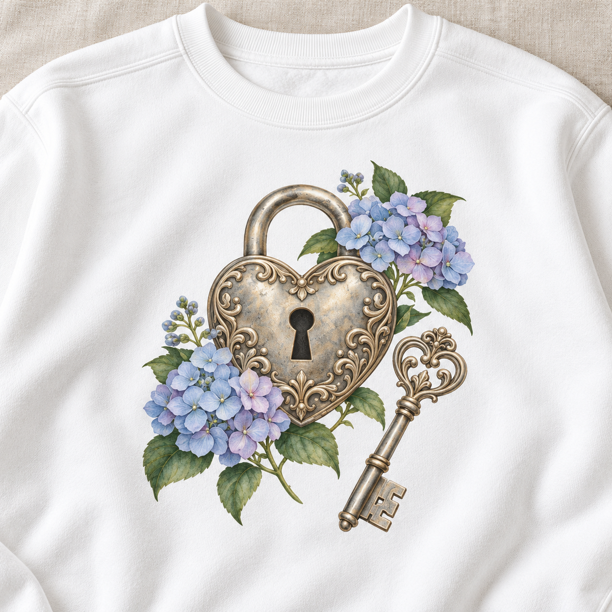 Close-up of a detailed watercolor silver filigree heart padlock and skeleton key among blue and purple hydrangeas, no text, printed large and centered on the front of a White 9.5 oz garment-dyed Comfort Colors 1566 sweatshirt