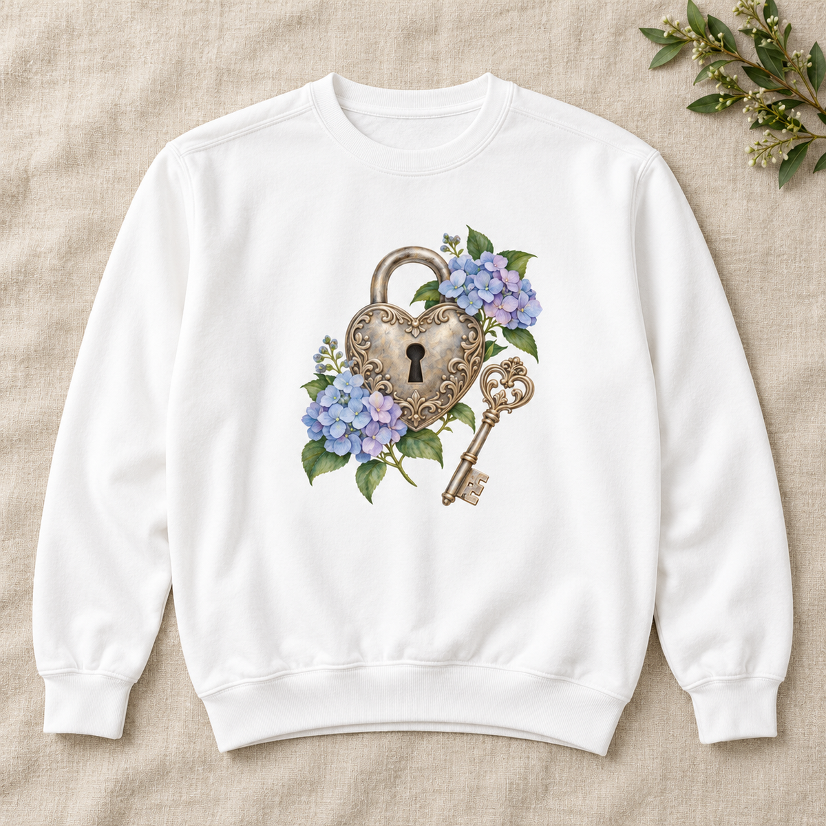 Detailed watercolor of a silver filigree heart padlock and skeleton key among blue and purple hydrangeas, no text, printed large and centered on the front of a White 9.5 oz garment-dyed Comfort Colors 1566 sweatshirt, shown flat
