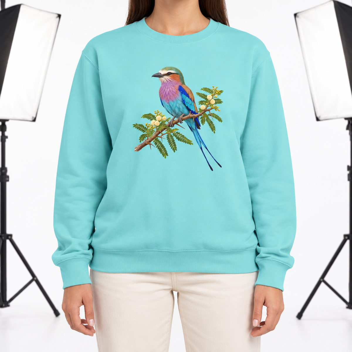 Woman wearing the Lilac-Breasted Roller on Acacia sweatshirt in Chalky Mint