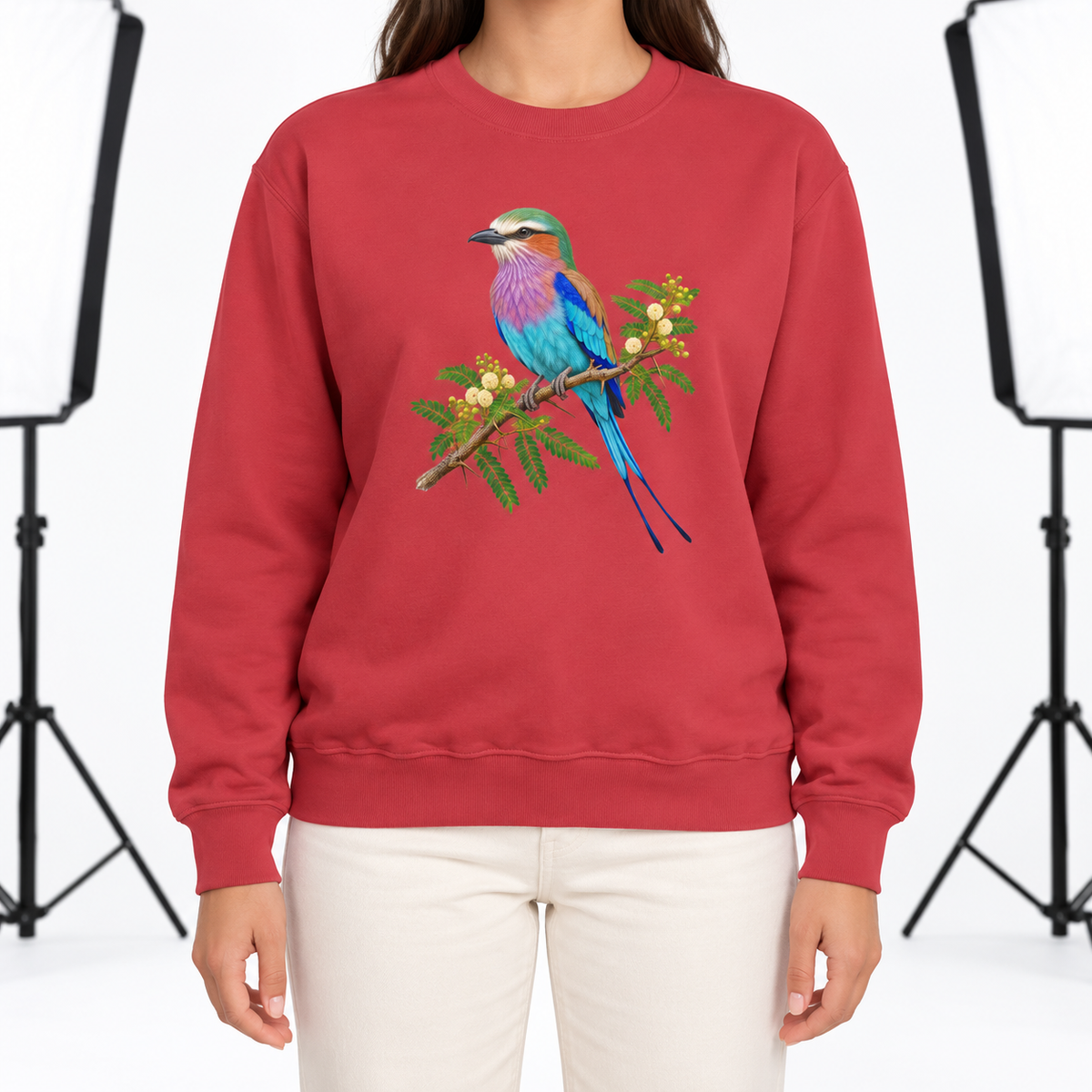 Woman wearing the Lilac-Breasted Roller on Acacia sweatshirt in Crimson