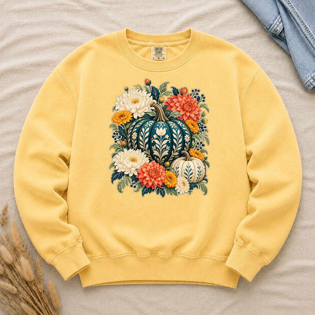 Blue pumpkin with cream botanical patterns and autumn flowers on a Butter yellow Comfort Colors crewneck sweatshirt