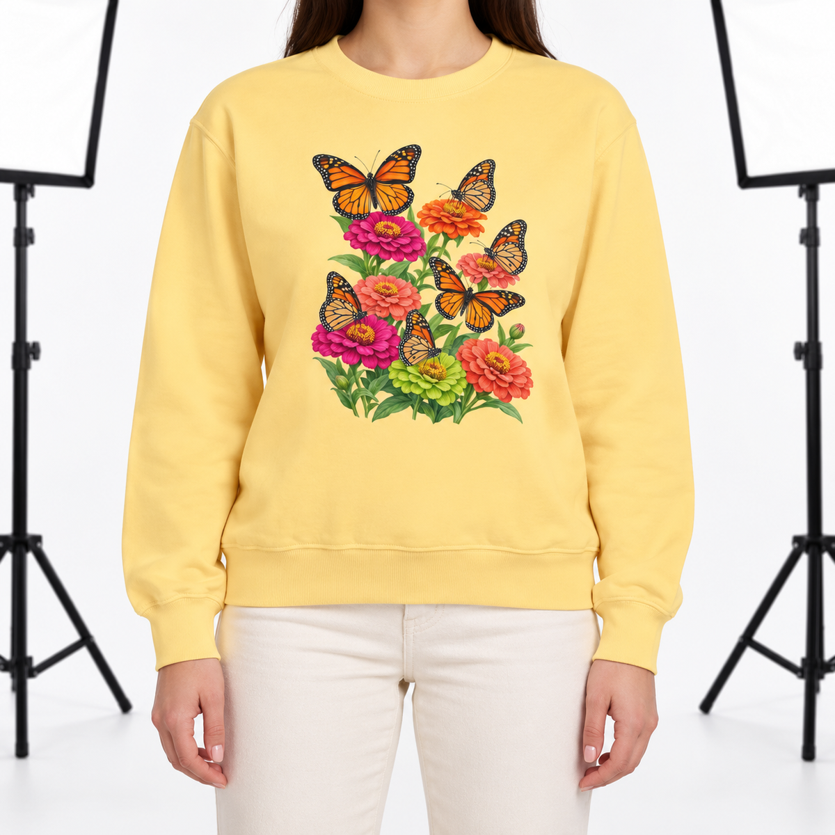 Woman wearing the Six Monarchs & Blooming Zinnias sweatshirt in Butter