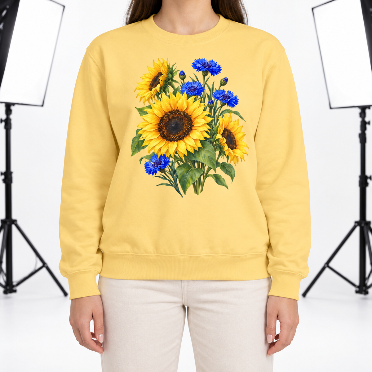 Woman wearing the Golden Sunflowers & Cobalt Cornflowers sweatshirt in Butter
