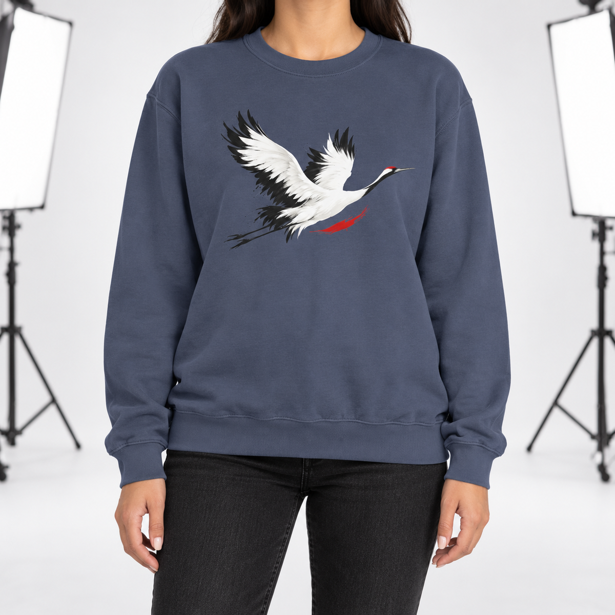 Denim Comfort Colors 1566 crewneck sweatshirt with a minimalist red-crowned crane in flight printed on the chest, worn by a model