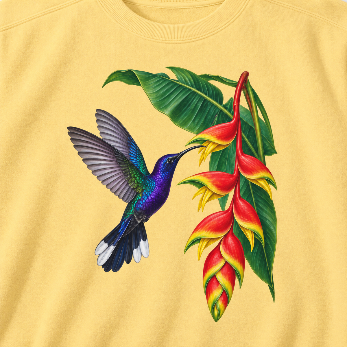 Close-up of the violet sabrewing and heliconia print on Butter fleece, showing the violet plumage, white-tipped tail and the red bracts with yellow tips