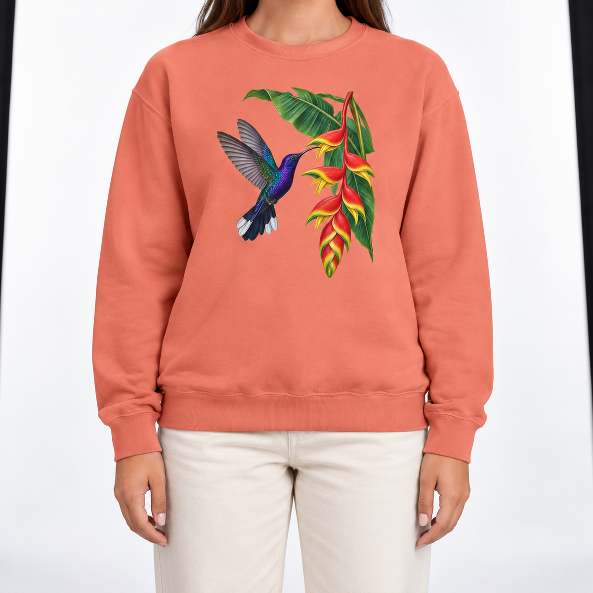 Woman wearing the Violet Sabrewing Hummingbird & Heliconia sweatshirt in Terracotta